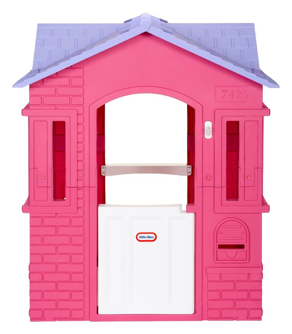 Pink Little Tikes Cape Cottage princess playhouse with working doors, windows, and shutters, perfect for imaginative outdoor play.