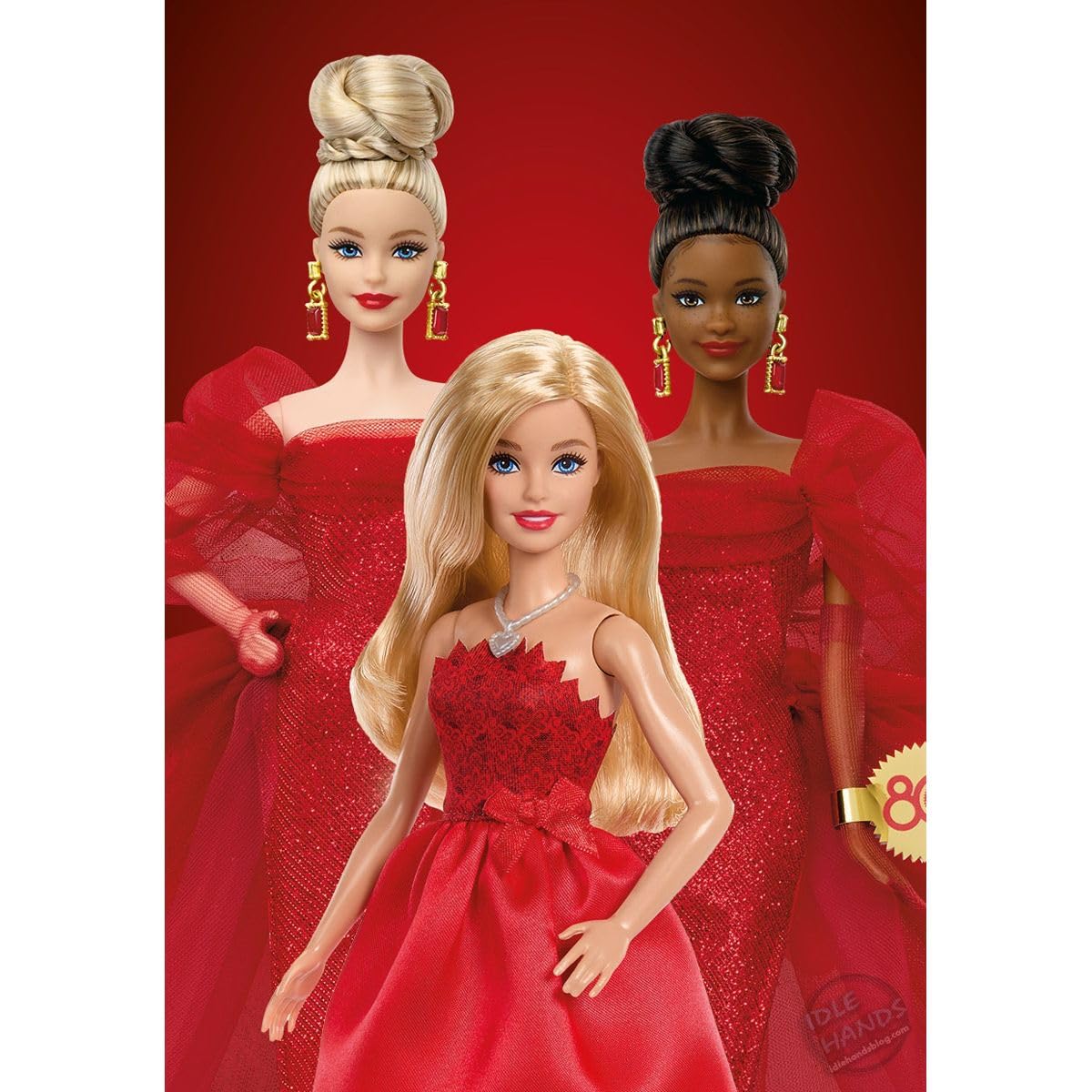 Barbie 80th Anniversary doll in a red dress with silvery shoes and necklace, showcasing her elegant celebration look.