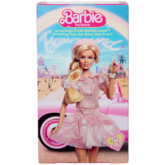 Barbie collectible doll of Margot Robbie in pink blouse and tutu skirt, styled hair, and matching jewelry.