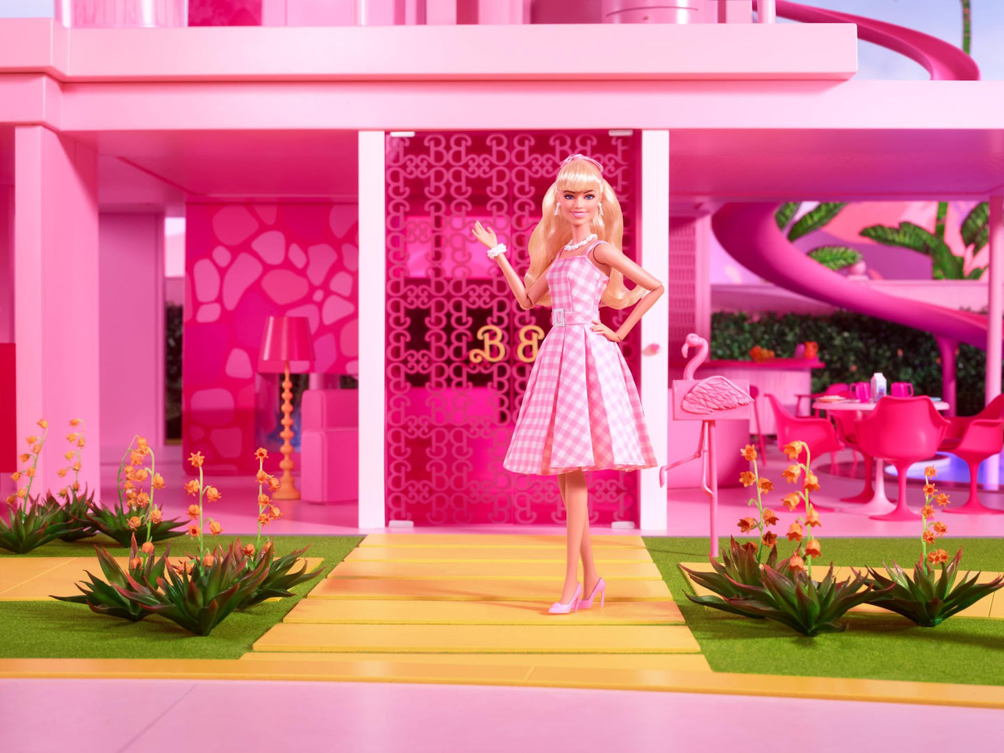 Barbie doll inspired by the movie, featuring Margot Robbie in a pink and white gingham dress with a daisy chain necklace.