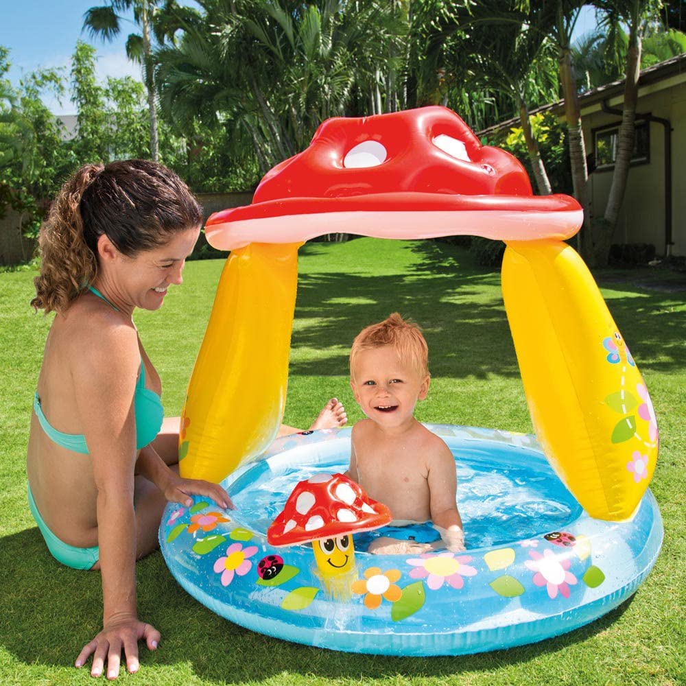Intex Mushroom Baby Pool 57114NP with colorful mushroom design and shallow water for infants in a sunny backyard setting.