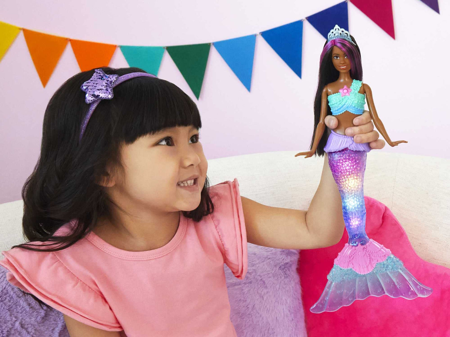 Barbie Dreamtopia mermaid doll with purple-streaked hair and light-up tail, showcasing water-activated features.