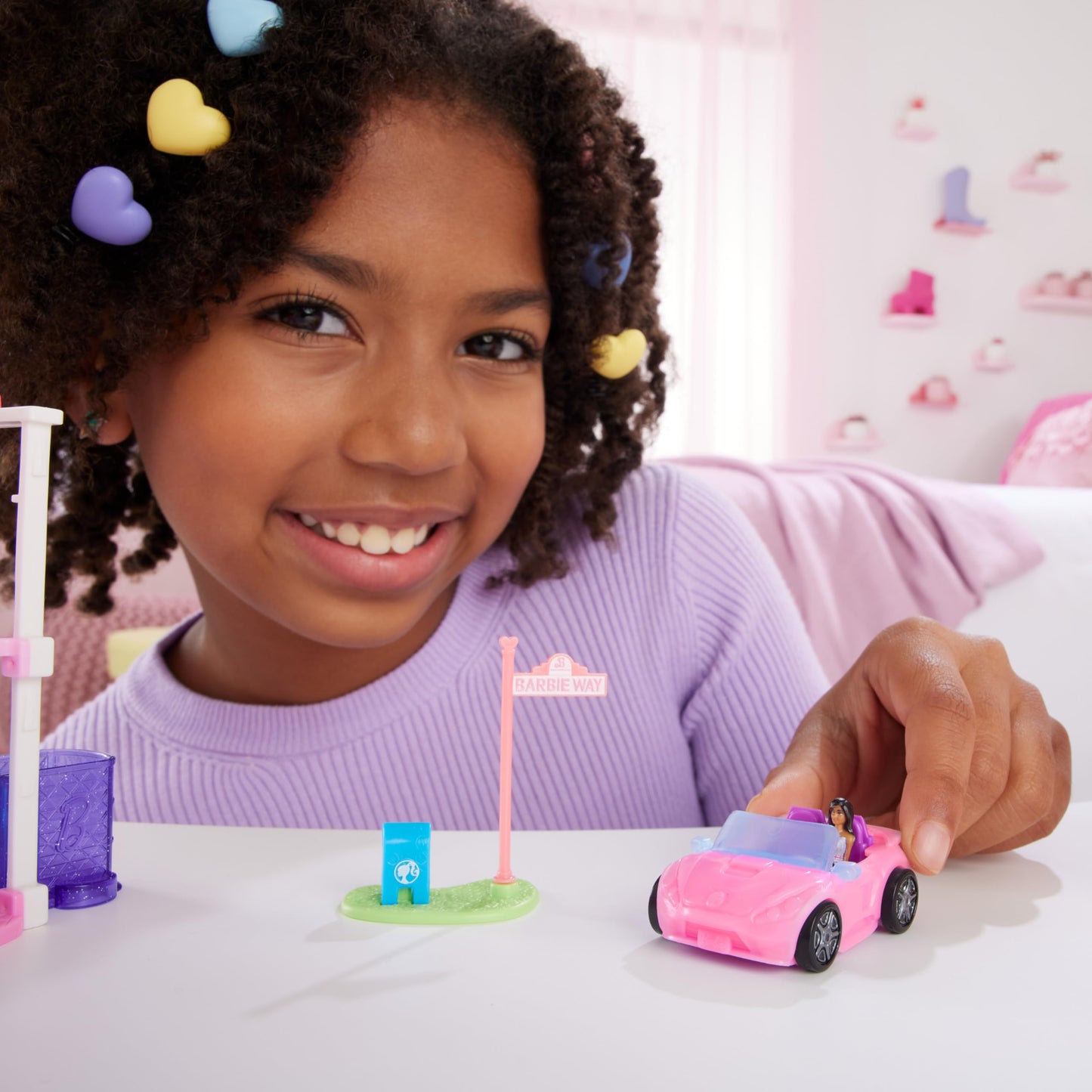 Mini BarbieLand doll and convertible car set with color-change feature, includes street sign accessory, by Barbie.