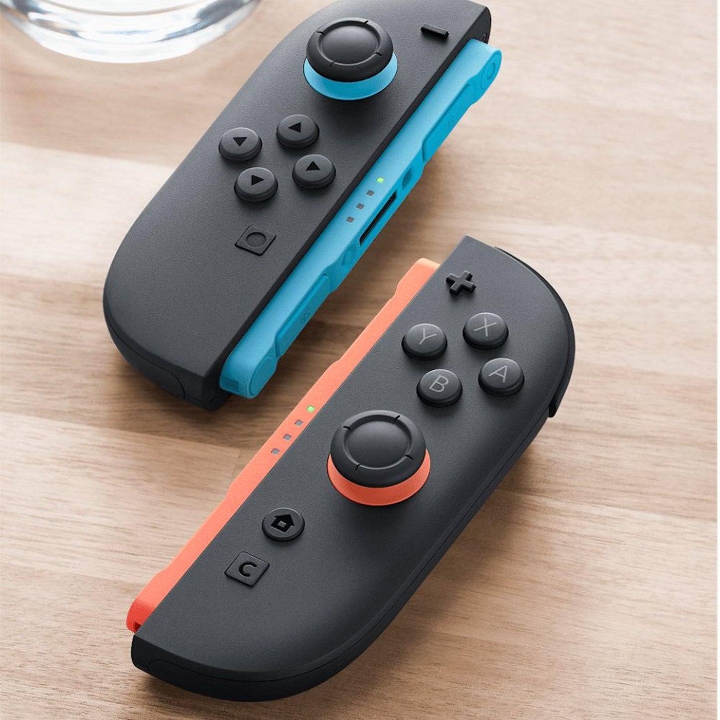 Nintendo Joy-Con controllers, a pair in light blue and light red, designed for Nintendo gaming consoles.