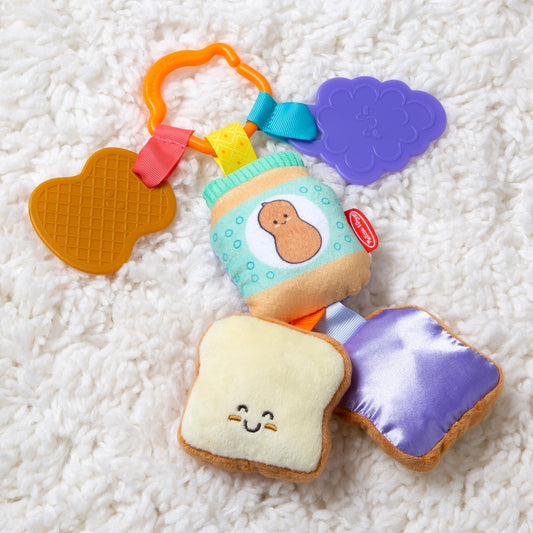 Melissa & Doug multi-sensory PB&J take-along clip-on baby toy with colorful textures for infants and toddlers.