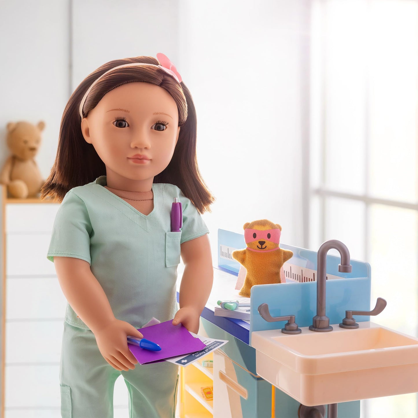 Our Generation doctor scrubs outfit for 18-inch dolls, featuring a surgical top and pants, ideal for pretend play.