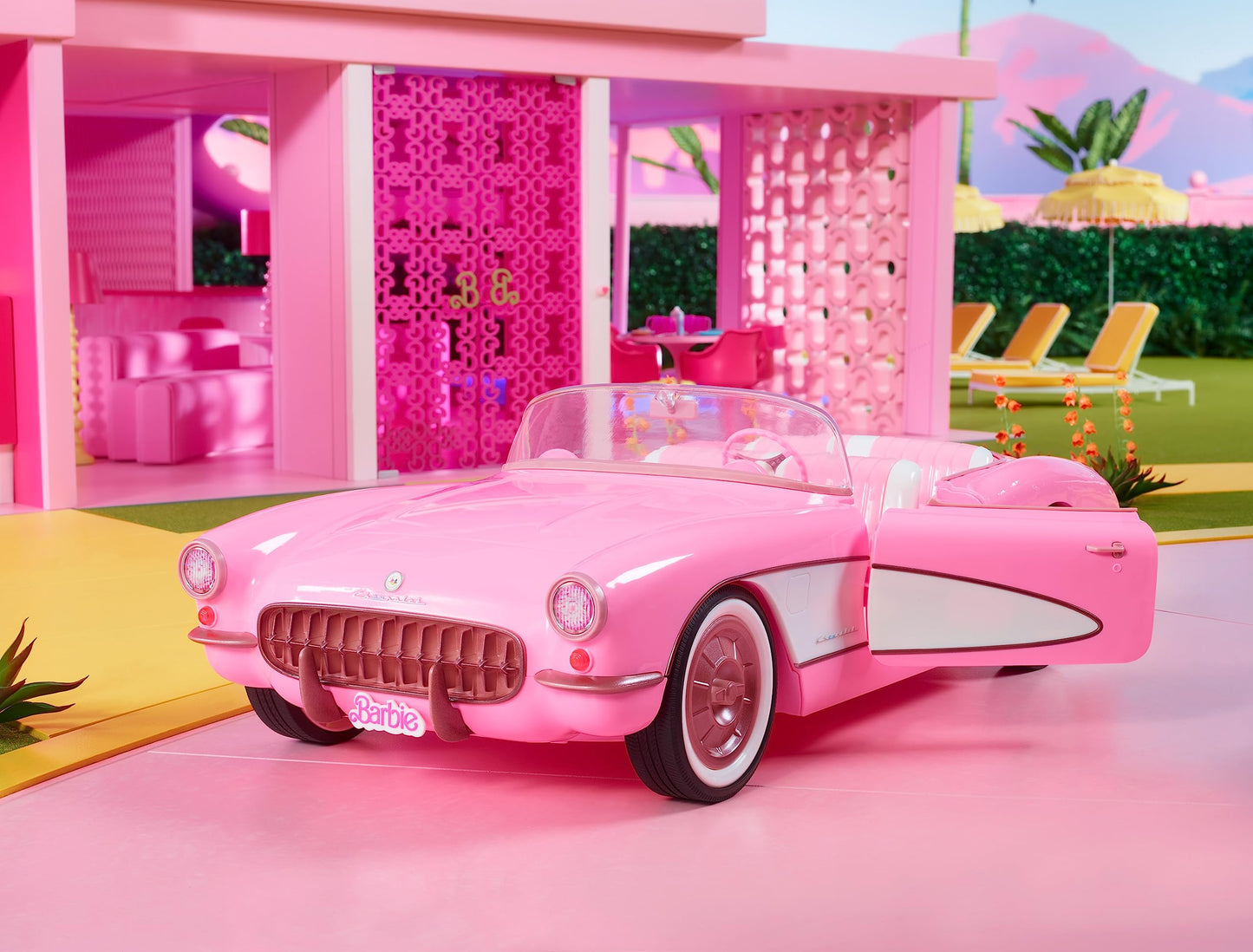 Vintage-inspired pink Corvette convertible by Barbie with white wall tires and trunk storage, ideal for collectors.