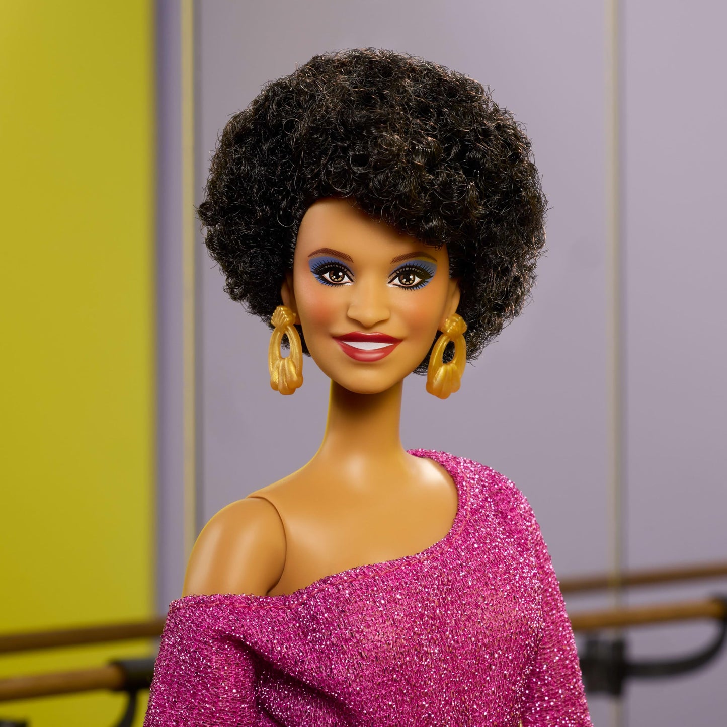 Barbie Signature Debbie Allen Tribute Doll in off-shoulder top, gold belt, purple fringe pants, and leg warmers.