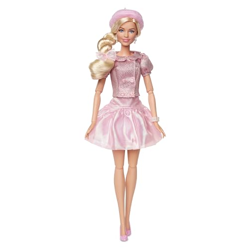 Barbie collectible doll of Margot Robbie in a pink blouse, tutu skirt, styled hair, and matching jewelry.