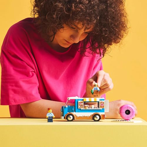 LEGO City donut truck toy featuring minifigures, mobile food stand, and colorful accessories for creative play.