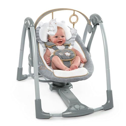 Ingenuity Swing 'n Go Deluxe baby swing with cushioned harness, plush toys, and sound features for infants 0-9 months.