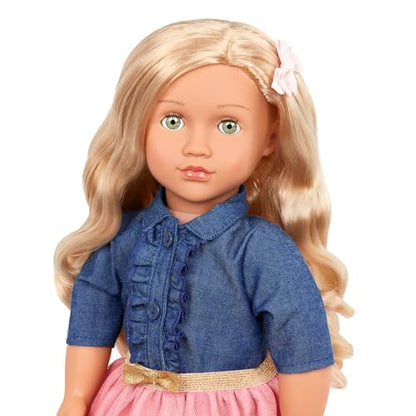 18-inch Our Generation Emily doll in pink dress and denim top, wearing stylish glasses and featuring a soft, huggable body.