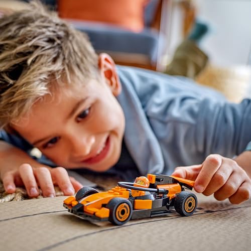 LEGO City F1 driver minifigure next to McLaren race car, ideal building toy for kids and motorsport fans.