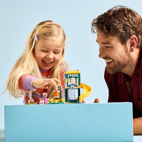 LEGO Bluey Playground Fun set featuring Bluey and Chloe minifigures, slide, see-saw, climbing frame, and plants.
