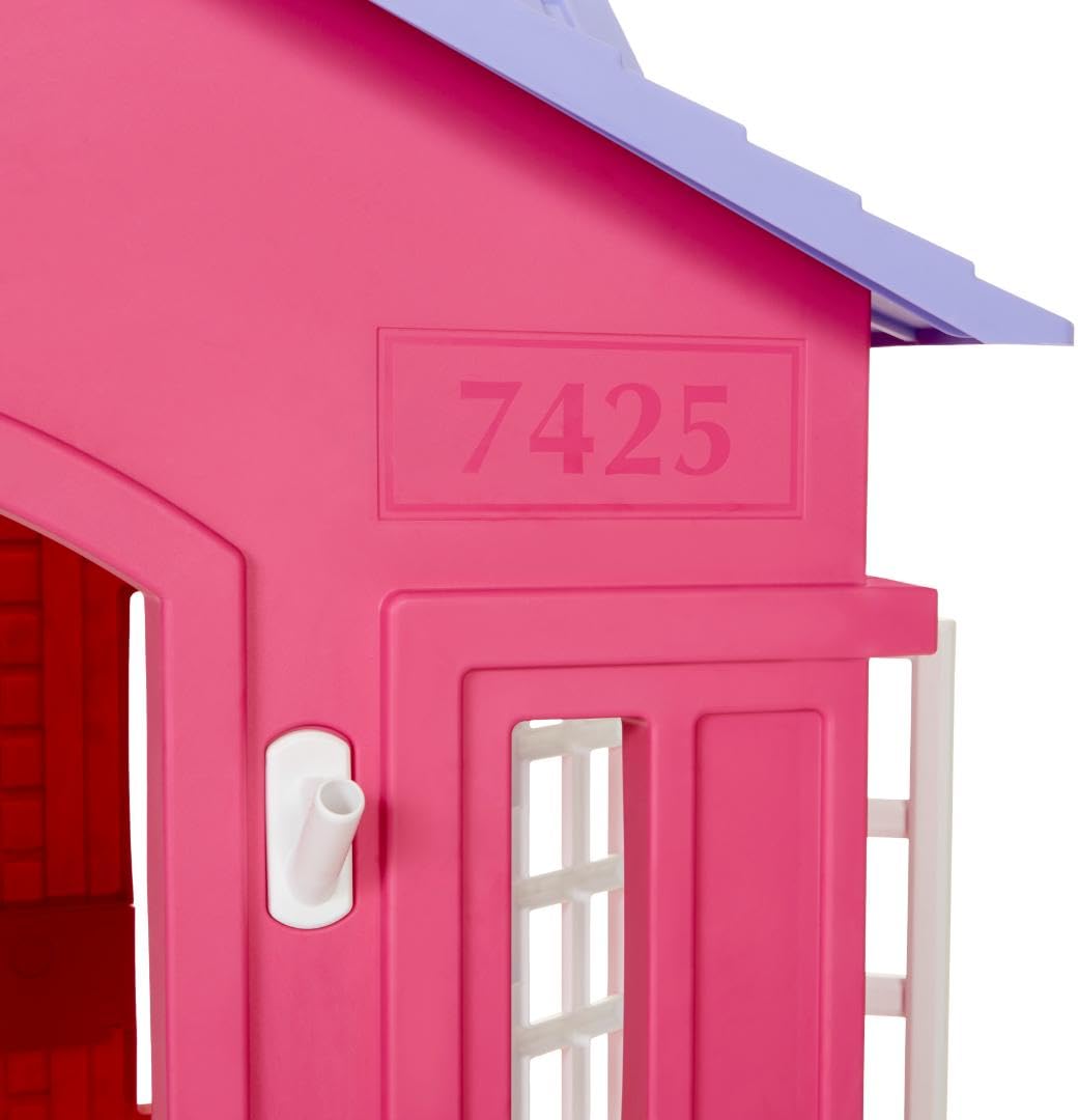 Pink Little Tikes Cape Cottage princess playhouse with working doors, windows, and shutters for kids' imaginative play.