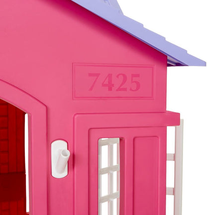 Pink Little Tikes Cape Cottage princess playhouse with working doors, windows, and shutters for kids' imaginative play.