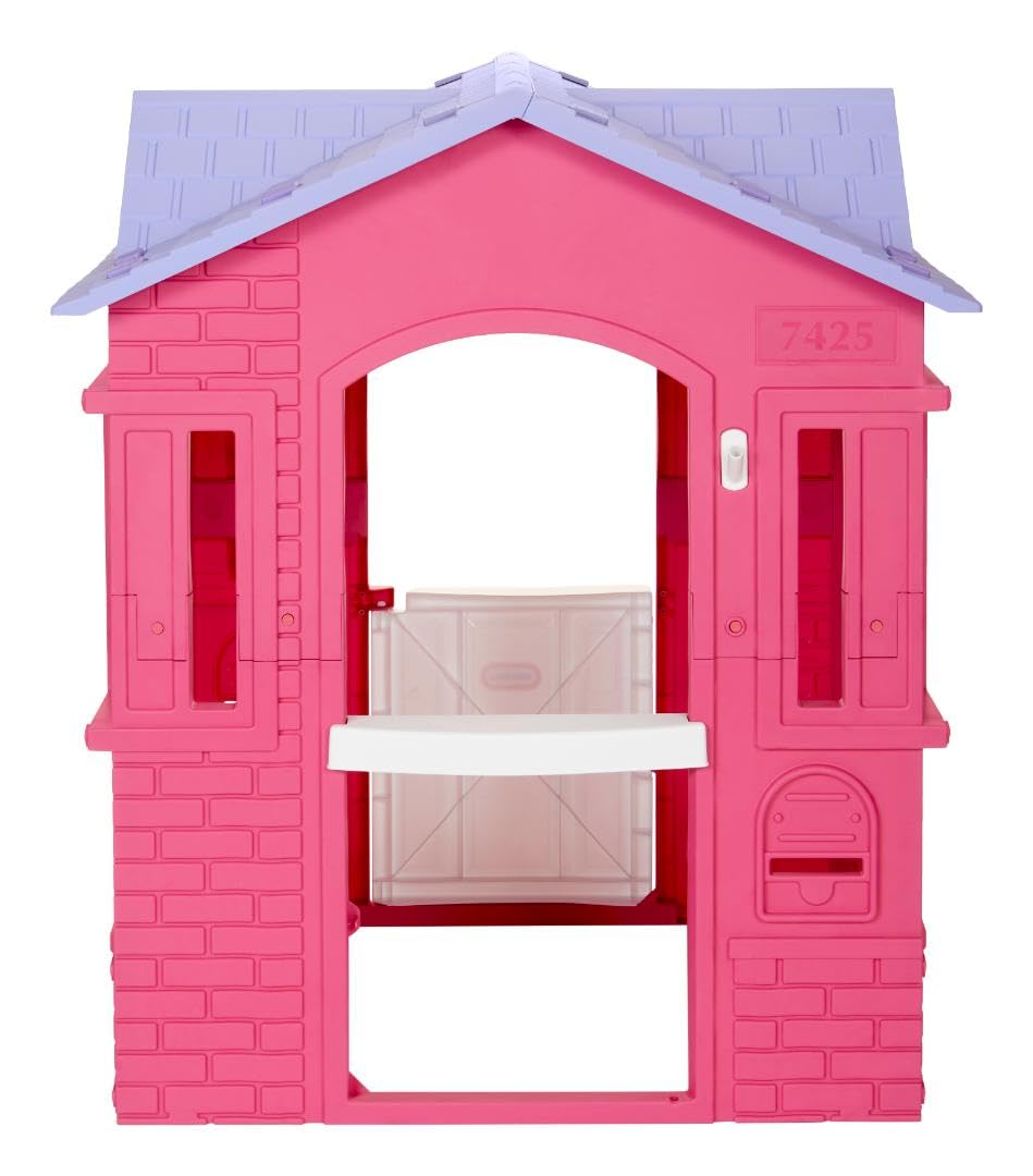 Pink Little Tikes Cape Cottage princess playhouse with working doors, windows, and shutters for kids' outdoor fun.