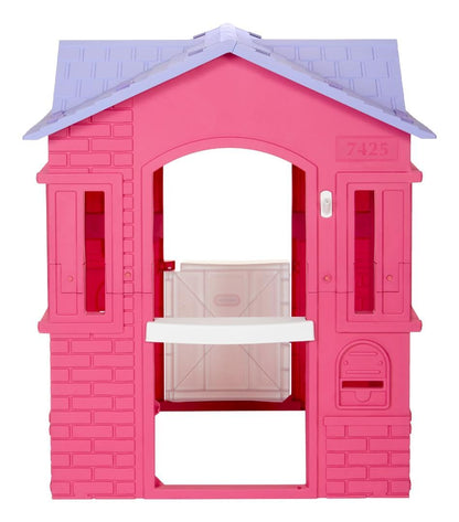Pink Little Tikes Cape Cottage princess playhouse with working doors, windows, and shutters for kids' outdoor fun.