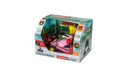 Pink Carrera RC Nintendo Mario Kart Pipe Kart featuring Peach character, remote-controlled toy car on a track.