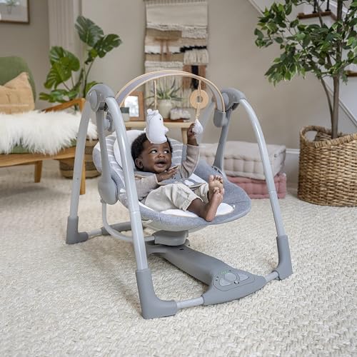 Ingenuity Swing 'n Go Deluxe baby swing with cushioned harness, plush toys, sounds, foldable and portable for infants 0-9 months.