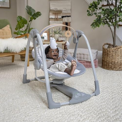 Ingenuity Swing 'n Go Deluxe baby swing with cushioned harness, plush toys, sounds, foldable and portable for infants 0-9 months.