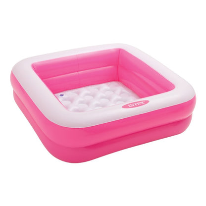 Intex inflatable square paddling pool in pink or lime green, measuring 86x86x25 cm, set up in a backyard.