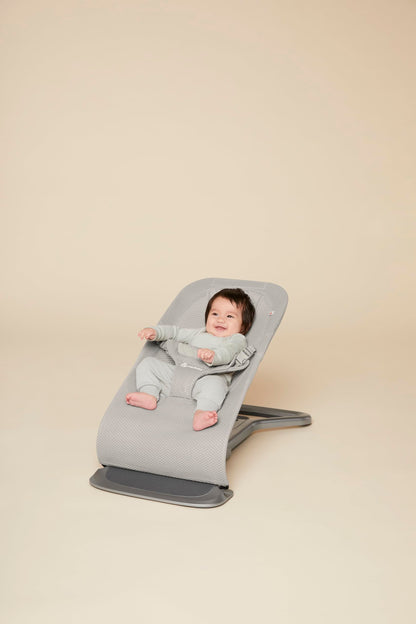 Ergobaby 3-in-1 Evolve Bouncer Mesh in light grey, ergonomic baby rocker with breathable fabric and newborn insert for infants and toddlers.