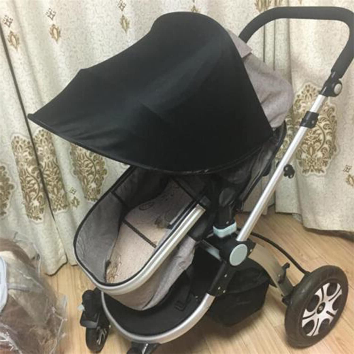 Black Esteopt pram sun shade cover with UPF50+ sun protection, breathable fabric, and foldable design for baby strollers and pushchairs.