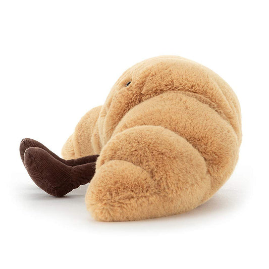 Jellycat Amuseable Croissant plush toy, 10 cm tall, 33 cm wide, with a smiling face and soft, textured fabric.