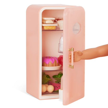 Our Generation pink mini fridge with play food accessories for dolls, featuring realistic design and 46cm size.