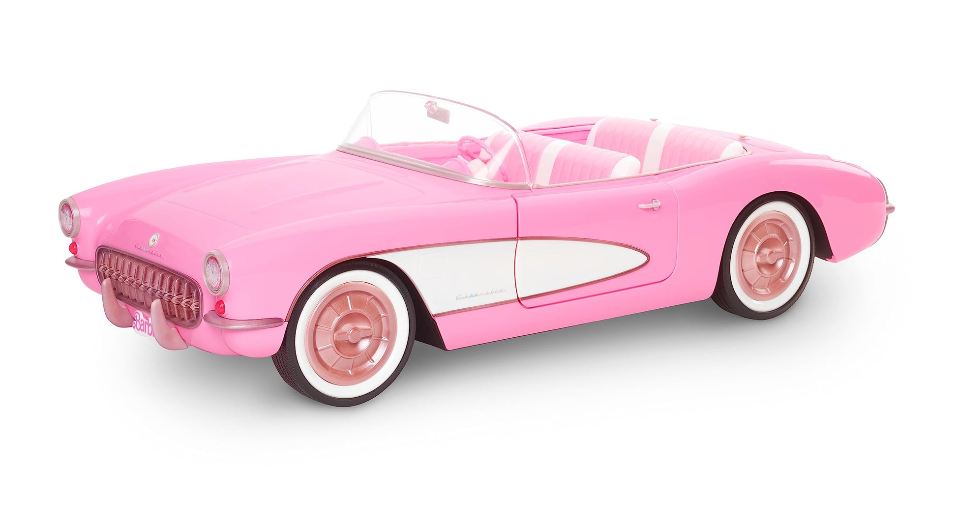 Vintage-inspired Barbie pink Corvette convertible with white wall tires and trunk storage, perfect for collectors.