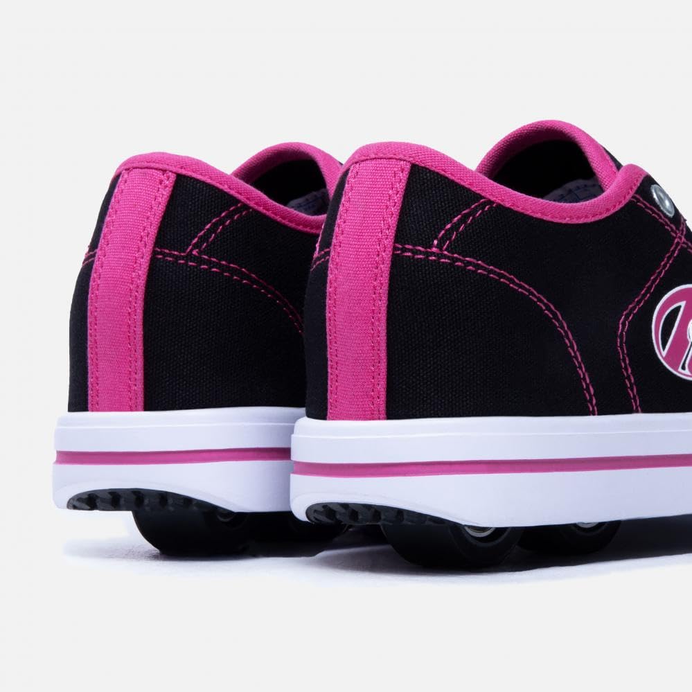 Heelys girls' skate shoes in black, white, and hot pink with wheels, size 3 UK, featuring sporty design and skate shoe style.