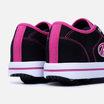 Heelys girls' skate shoes in black, white, and hot pink with wheels, size 3 UK, featuring sporty design and skate shoe style.