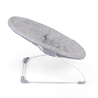 Red Kite Bambino Bouncer in grey fabric with a padded seat and safety harness, designed for soothing and entertaining babies.