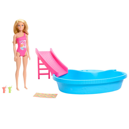 Barbie doll in a pink swimsuit with a pool, slide, towel, and drink accessories in a playful tropical setting.