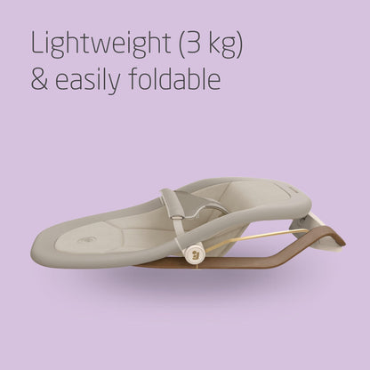 Maxi-Cosi Dove baby bouncer in elegant beige with natural bouncing, foldable and portable design, made from eco-friendly recycled fabrics.
