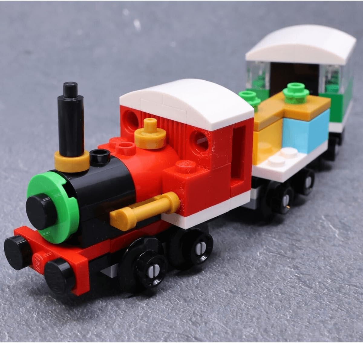 LEGO Creator 30584 Winterlicher Weihnachtszug set featuring a festive train with colorful bricks and holiday decorations.