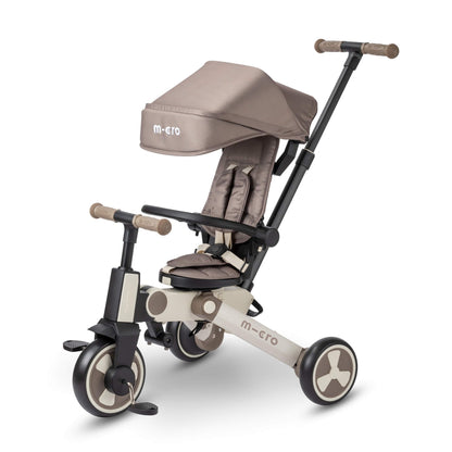 Latte brown Micro FlexiTrike foldable toddler tricycle with parent handle and 360-degree rotating seat for ages 6+ months.
