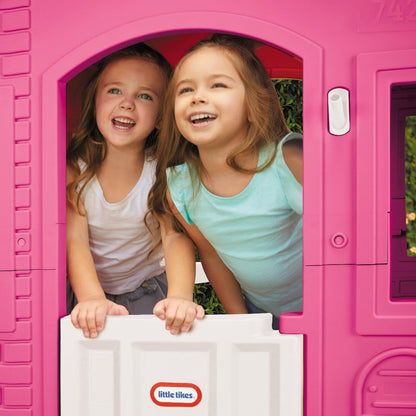 Pink Little Tikes Cape Cottage princess playhouse with working doors, windows, and shutters suitable for children.