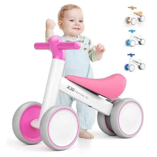 XJD pink and white baby balance bike for toddlers, designed for 10-24 months, featuring no pedals and a sturdy frame.