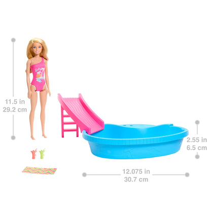 Barbie doll in tropical pink swimsuit beside a pool with slide, towel, and drink accessories in vibrant playset scene.