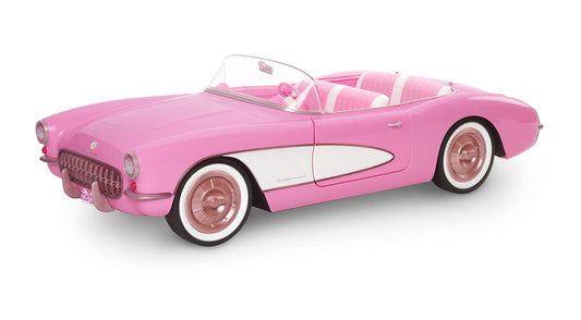 Vintage-inspired Barbie pink Corvette convertible with white wall tires and trunk storage, collectible toy car.
