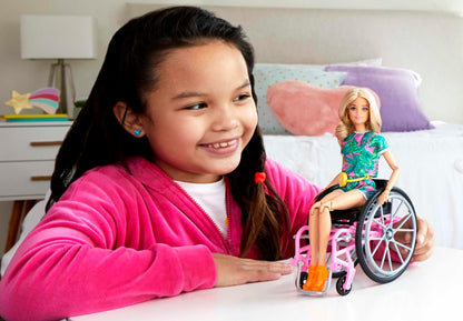 Barbie Fashionistas Doll #165 with long blonde hair, wheelchair, tropical romper, orange shoes, and lemon fanny pack for kids ages 3-8.