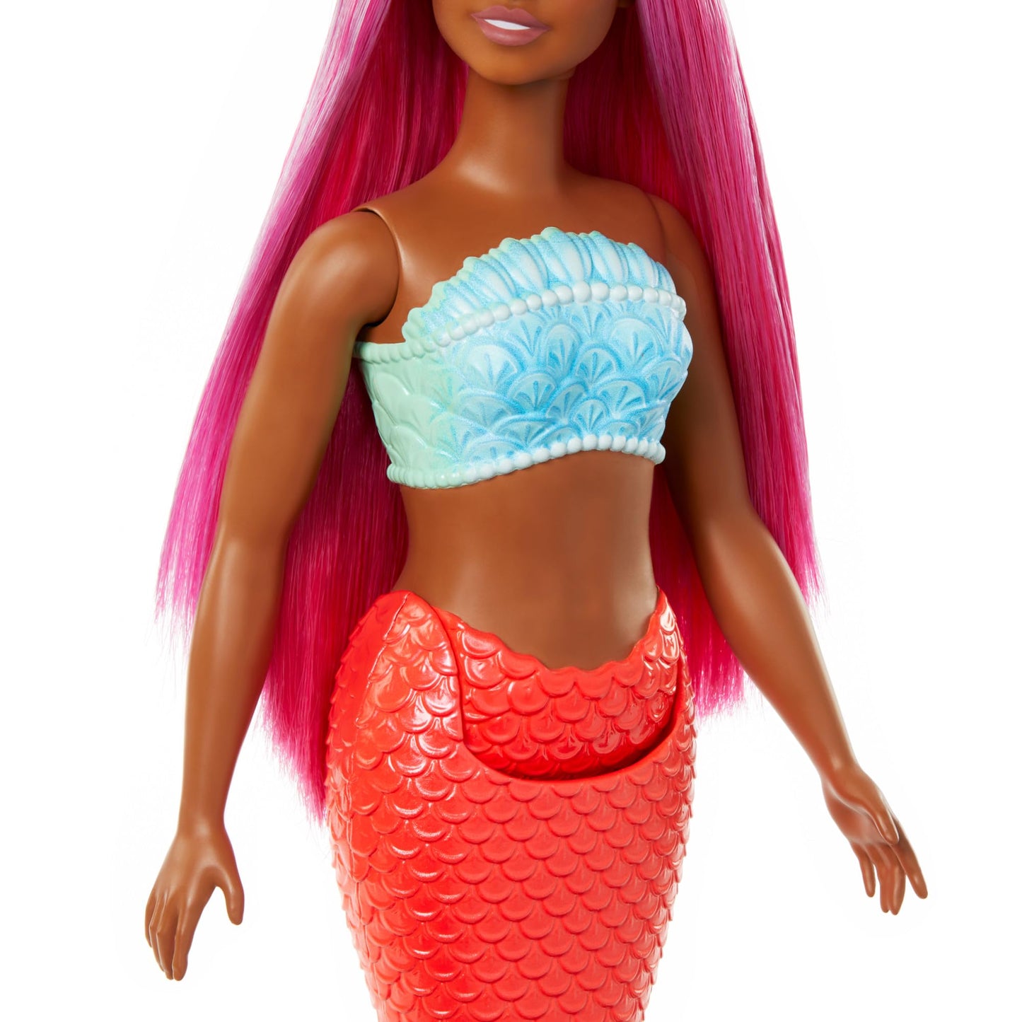 Barbie mermaid doll with magenta hair, shell bodice, and tropical red tail in a vibrant underwater setting.