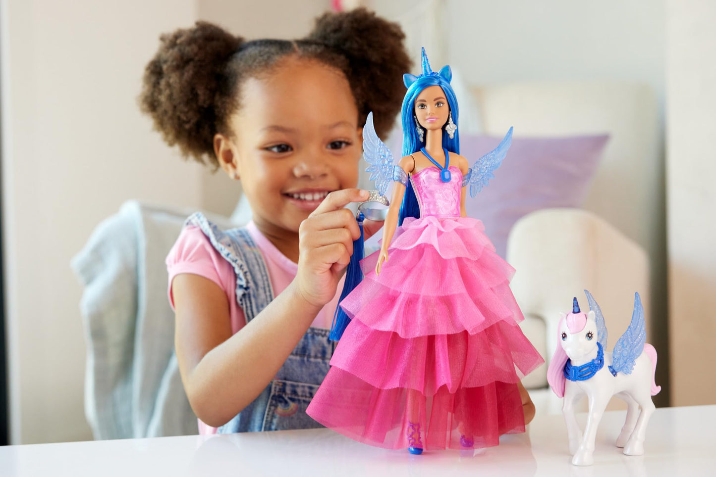 Barbie 65th Anniversary Unicorn Toy Doll with blue hair, pink gown, sapphire wings, and a pet alicorn.