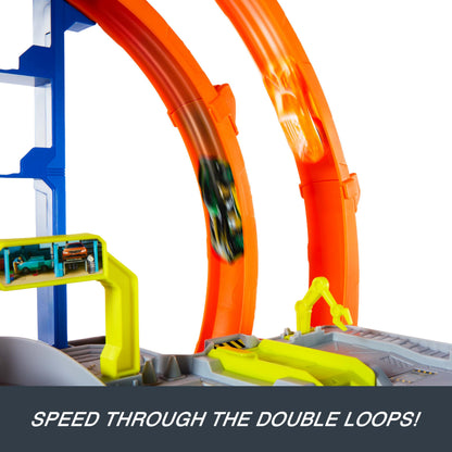Hot Wheels toy car track set featuring loops, storage for 37 cars, and die-cast car and helicopter.
