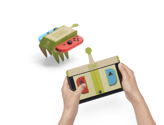 Nintendo Labo Variety Kit with colorful cardboard toy components and Nintendo Switch screen in the background.