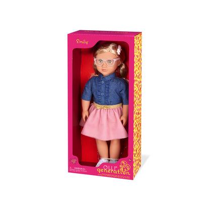 18-inch Our Generation Emily doll in pink dress and denim top, wearing stylish glasses, with a soft huggable body.