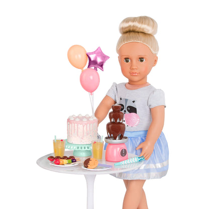 18-inch Our Generation doll accessories featuring a birthday cake, colorful balloons, and pretend food for imaginative play.