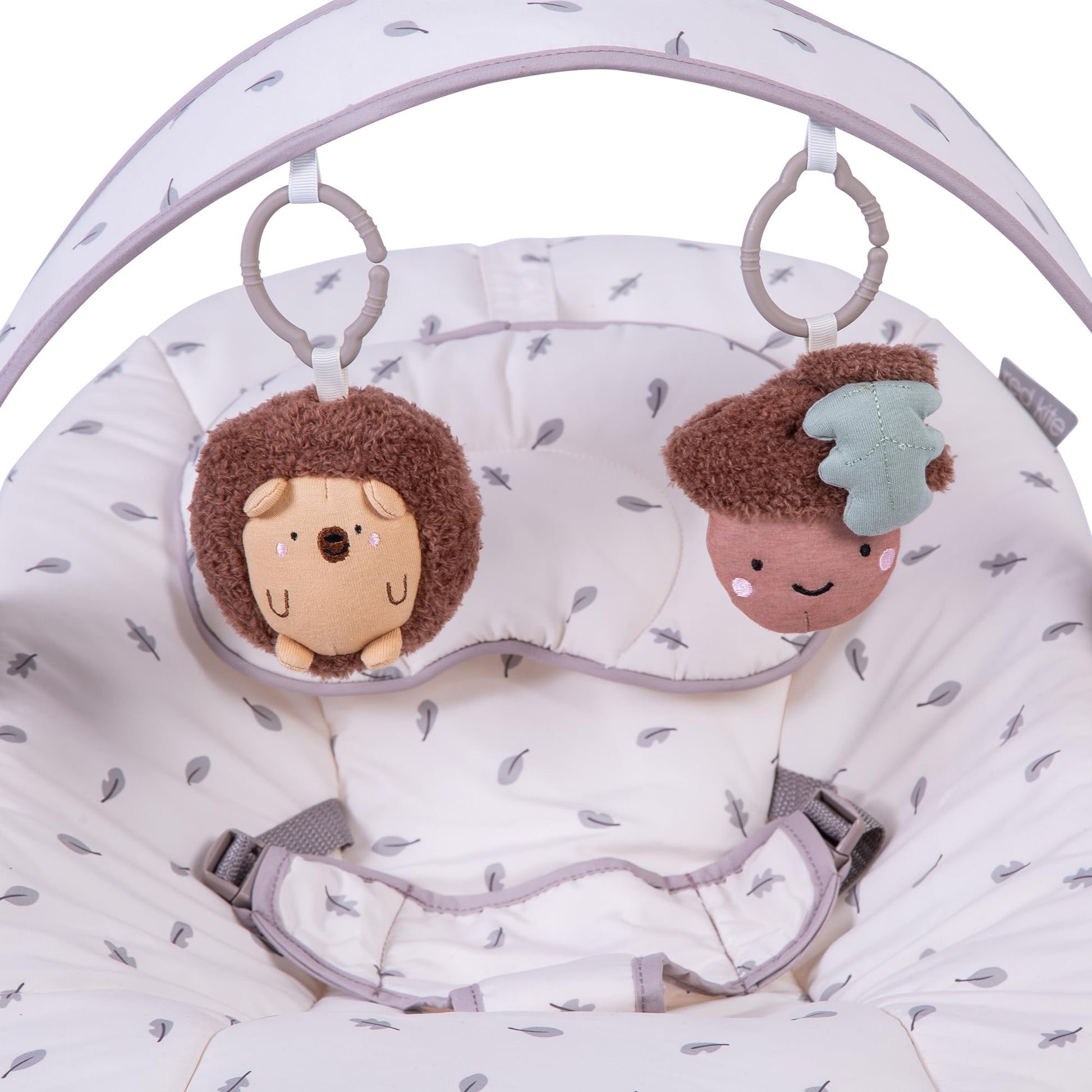 Red Kite Cozy Bounce musical baby bouncer in woodland walks pattern with plush fabric and toy arch for infants.